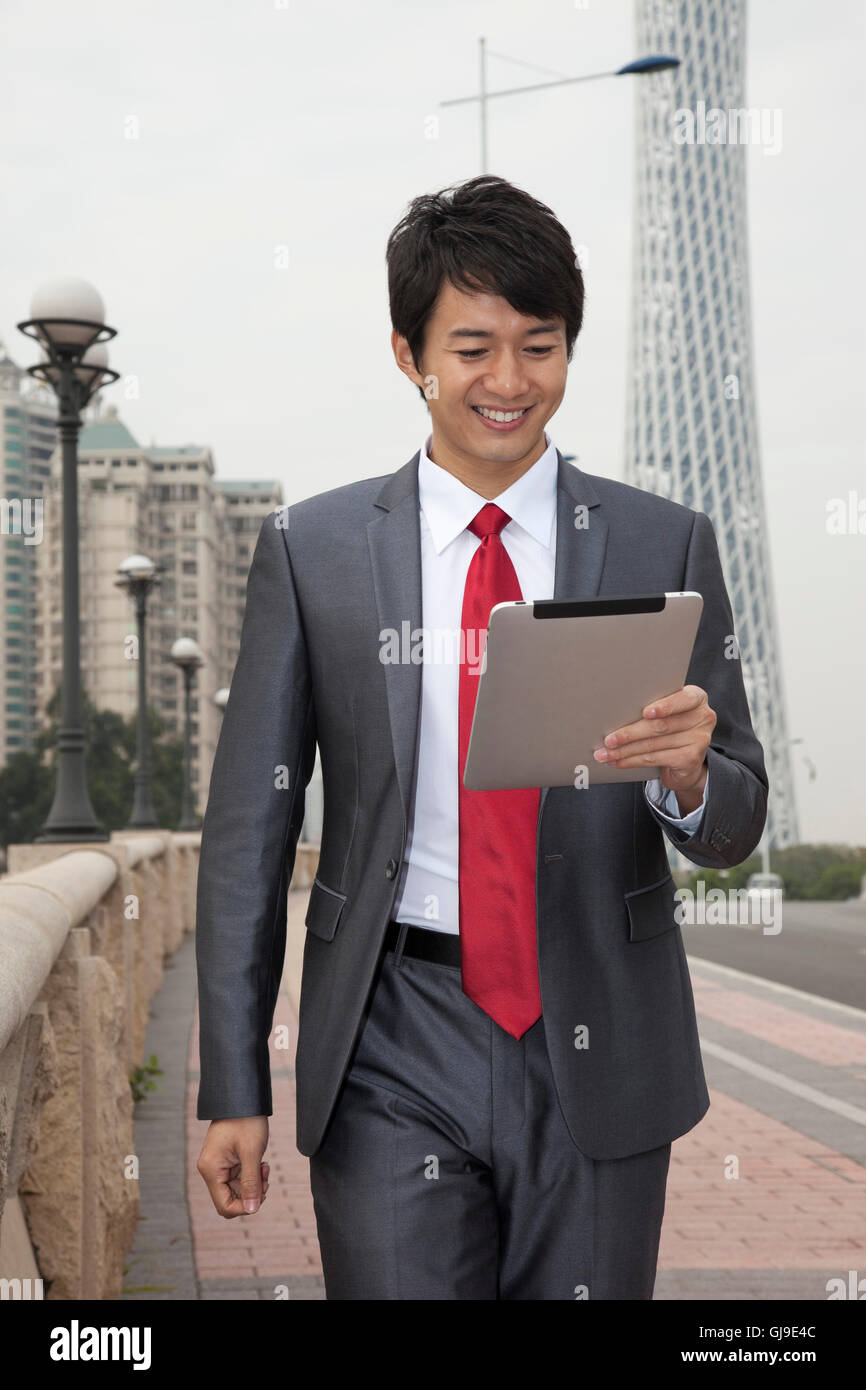 Young business man outside office building Stock Photo - Alamy