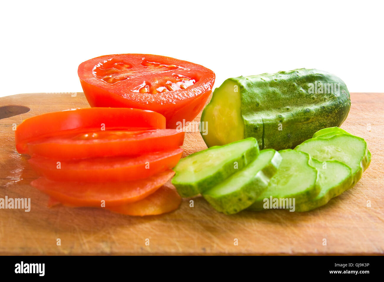 cucumber and tomato slices on a cutting board Stock Photo - Alamy