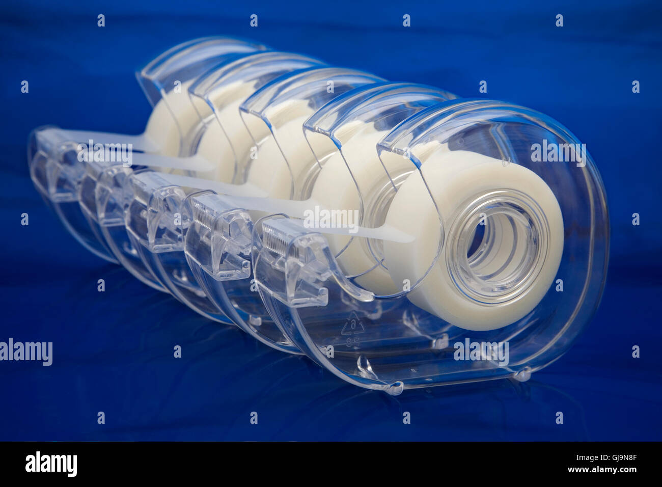 A row of Plastic tape dispensers for wrapping christmas and birt Stock