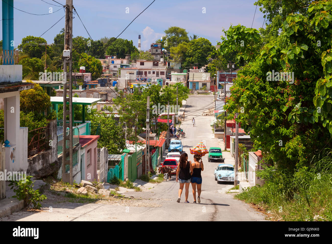 Everyday life looking down a street in the municipality of Guanabacoa, Havana, Cuba. Stock Photo