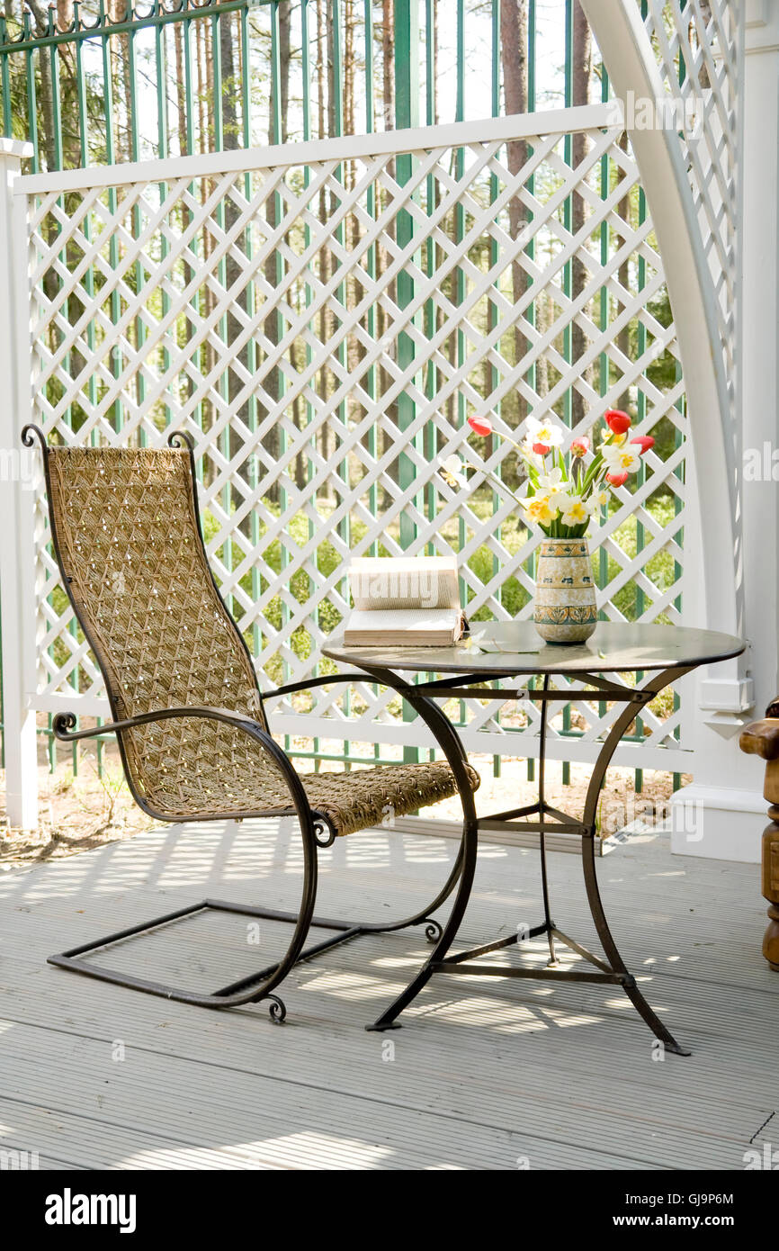 rocking chair and little table on the veranda Stock Photo