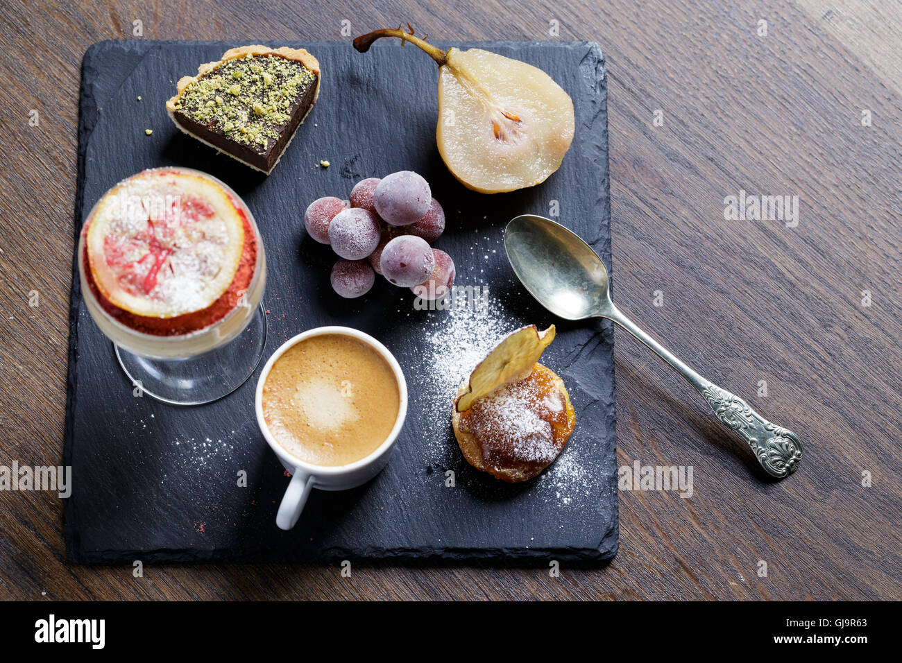Mix of desserts including espresso coffee served on a slate plate Stock Photo