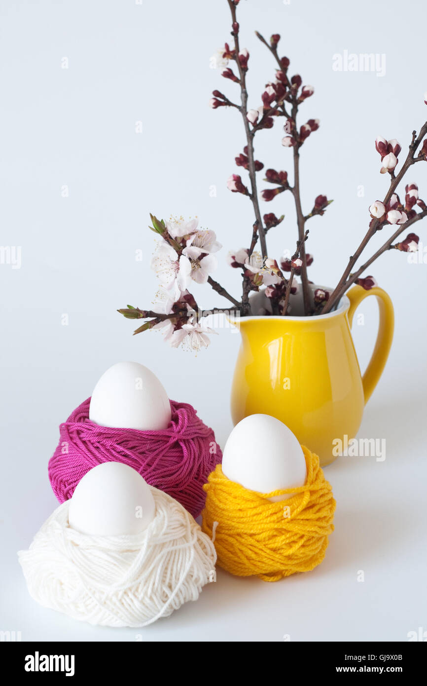 Decorative Easter eggs and a bunch of sprigs of cherry blossoms Stock