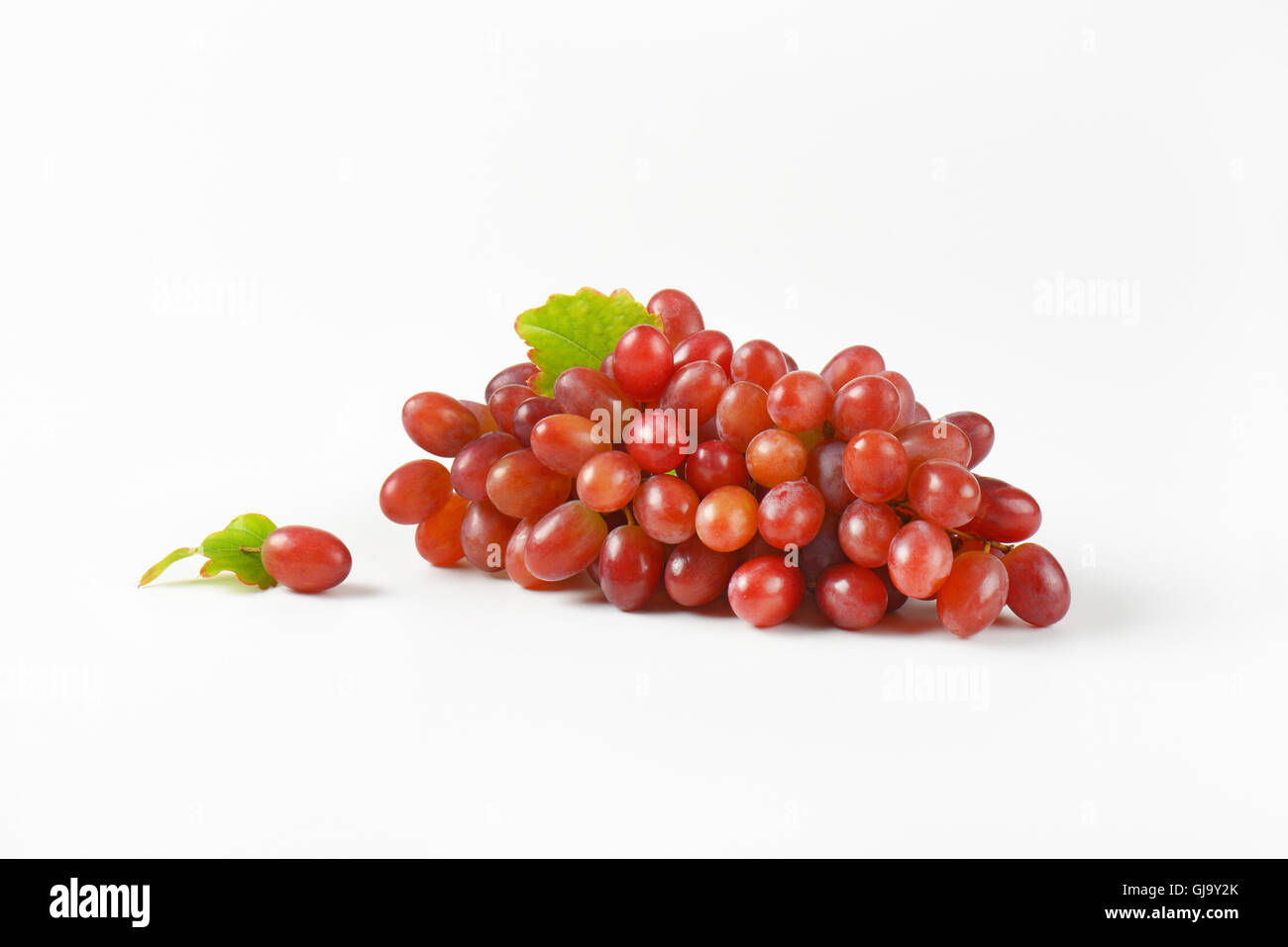 bunch of red grapes on white background Stock Photo Alamy