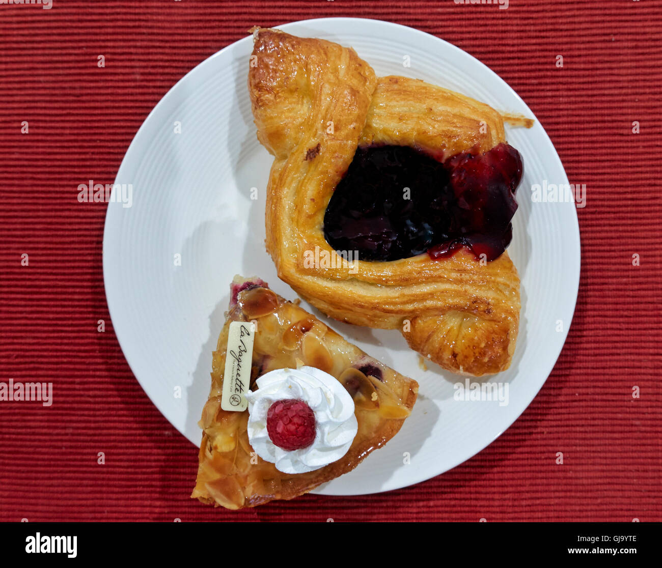 Fancy cakes including Bakewell tart and Danish pastry. Stock Photo