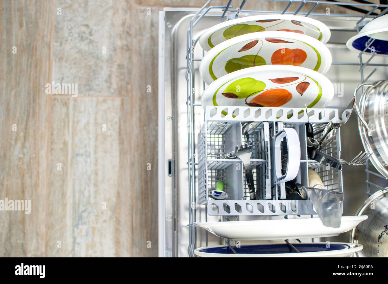 chores clean dishes and cutlery in the dishwasher Stock Photo Alamy