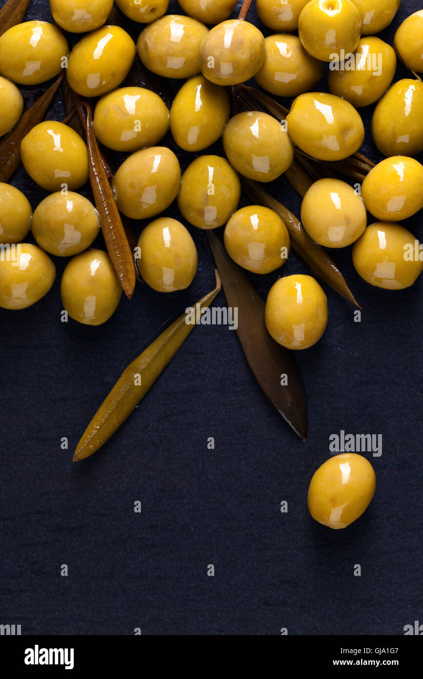 canned green olives on a black background Stock Photo Alamy