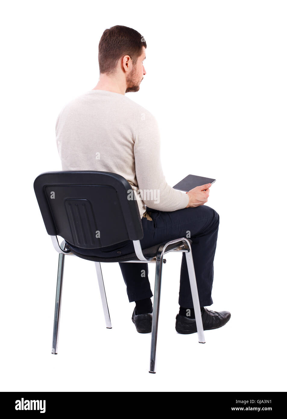 back view of man sitting on chair and looks at the screen Stock Photo -  Alamy