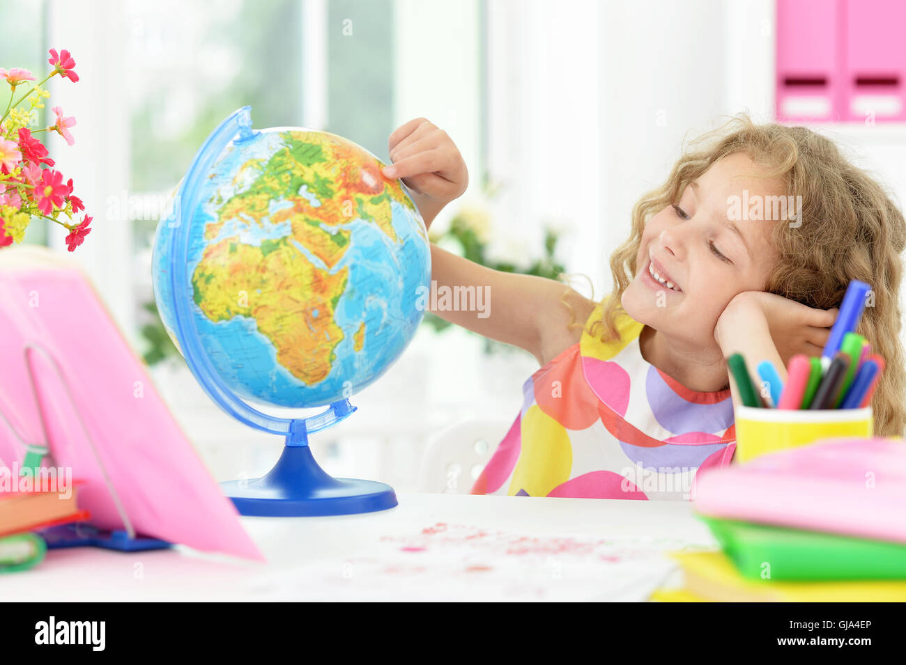 Cute student girl with books and globe Stock Photo - Alamy
