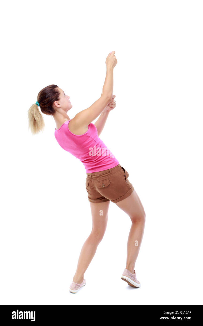 Girl Standing With Rope back view of standing girl pulling a rope from the top or cling Stock ...