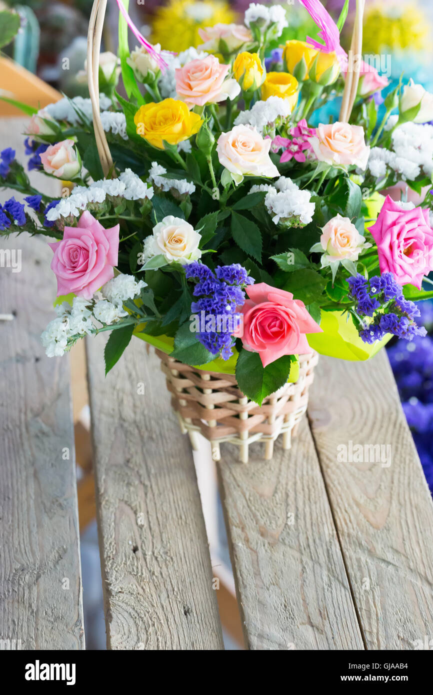 bouquet of flowers in a wicker basket. Stock Photo