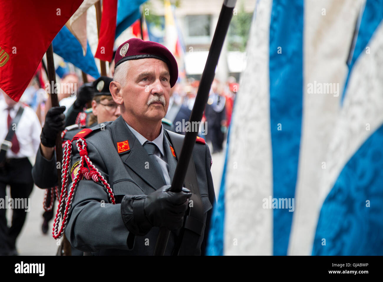 Zurich, Switzland. A flag bearer wears traditional dress at a ceremony in Zurich in celebration of Swiss National Day. Stock Photo
