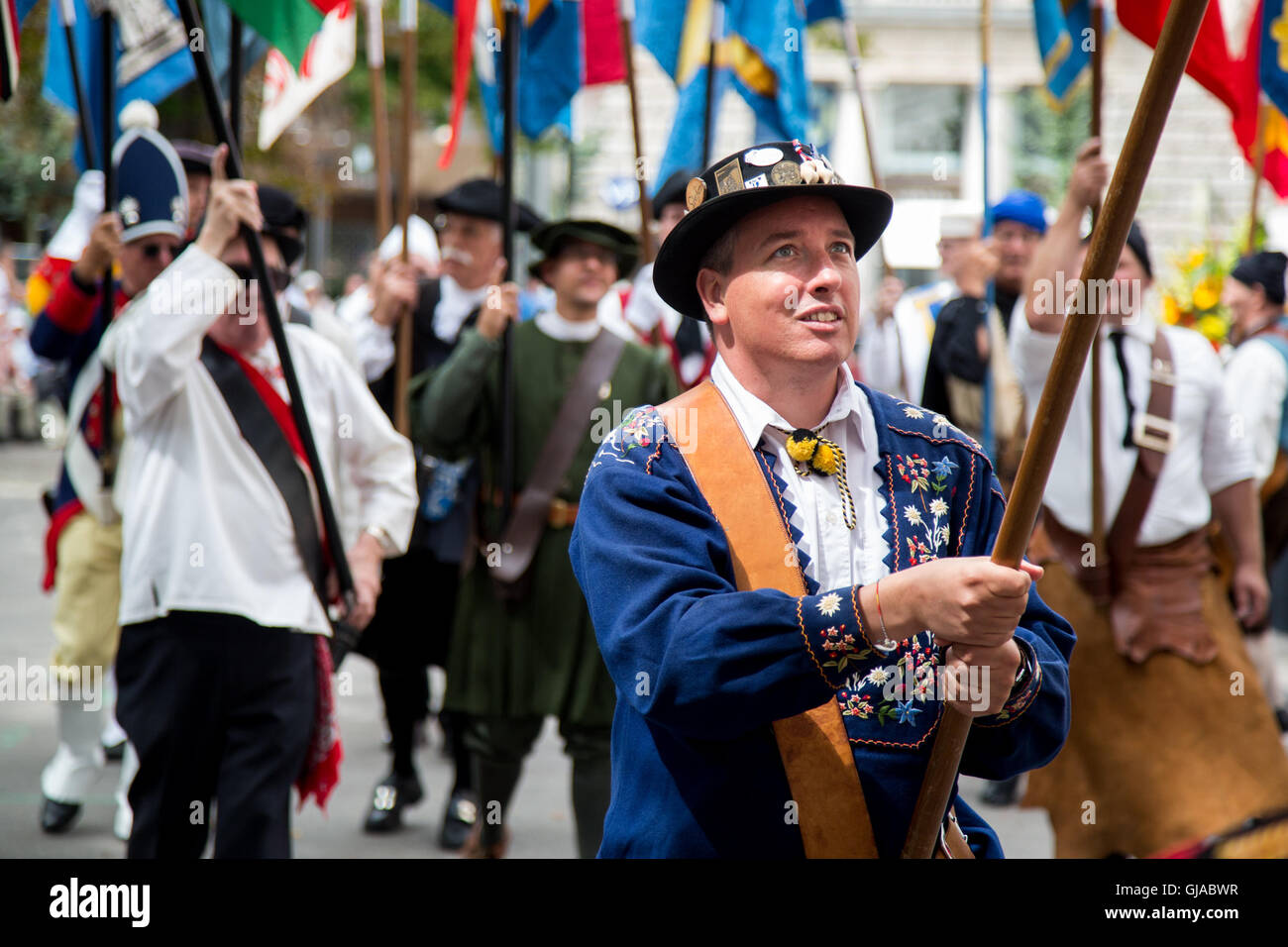 Zurich, Switzland. Flag bearers wear traditional dress at a ceremony in Zurich in celebration of Swiss National Day. Stock Photo