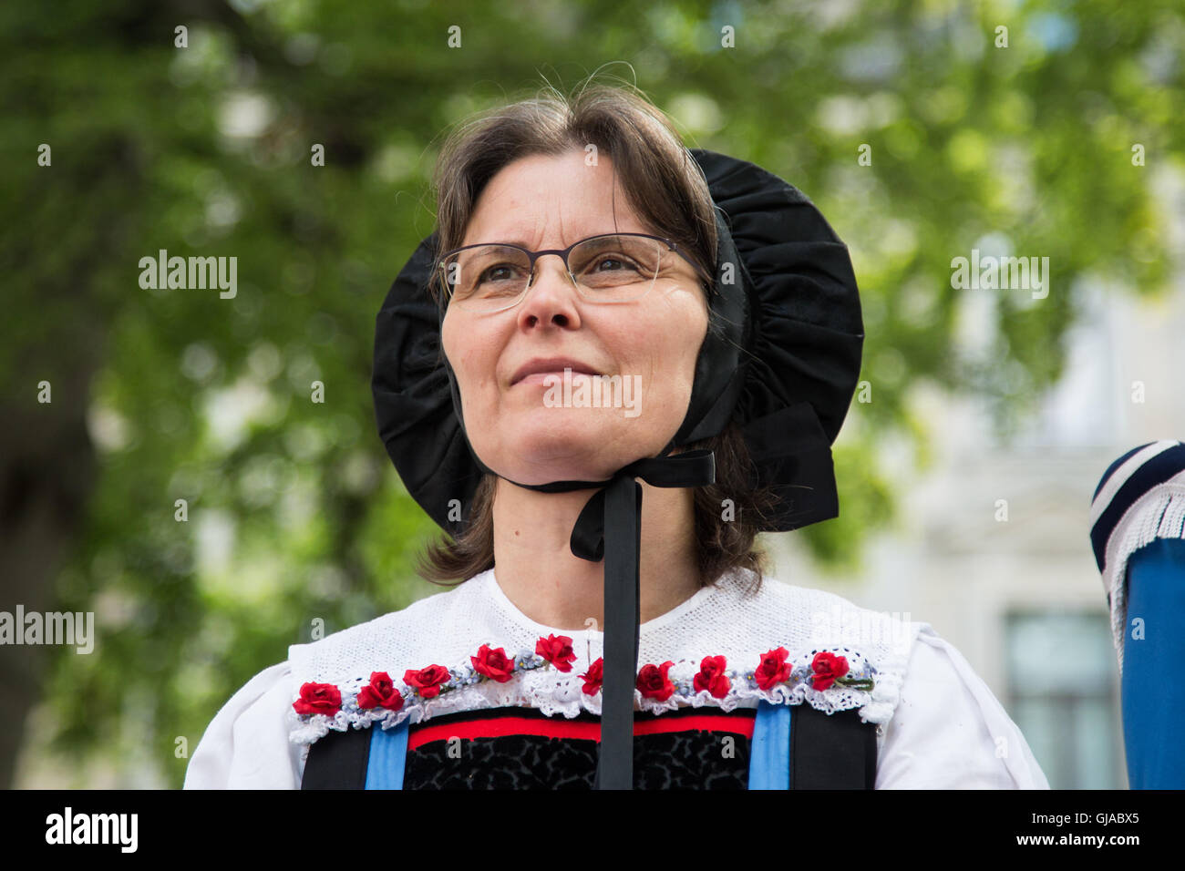 A woman wears traditional dress at a ceremony in Zurich in celebration of Swiss National Day. Stock Photo