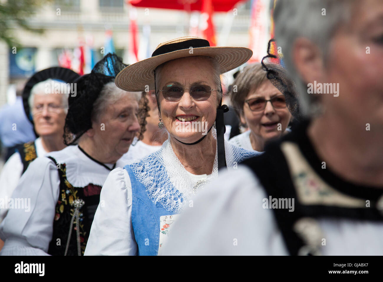 Women wear traditional dress at a ceremony in Zurich in celebration of Swiss National Day. Stock Photo
