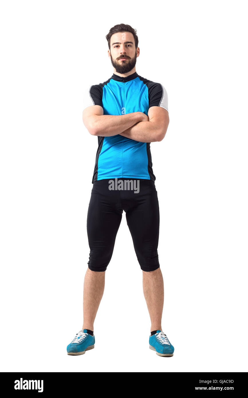 Muscular fit sportsman cyclist in sportswear with crossed arms looking at camera. Full body length portrait isolated on white Stock Photo
