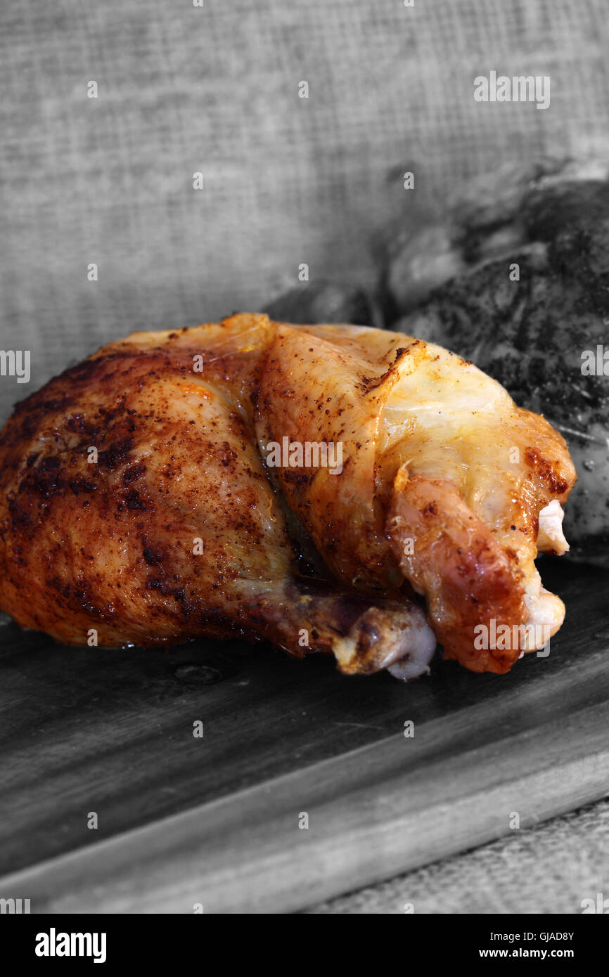 Roast chicken thigh chopping board Stock Photo Alamy