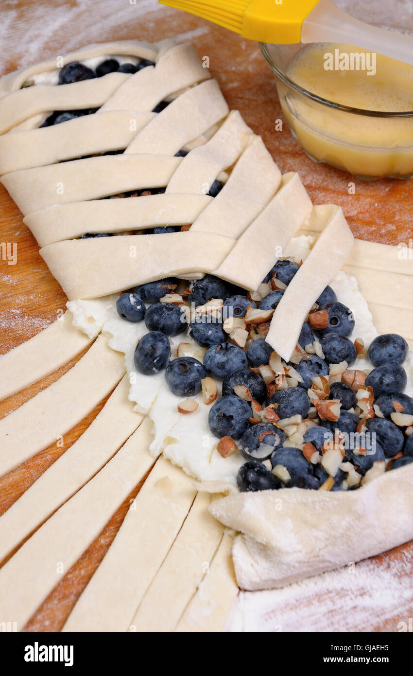 Pie stuffed with cheese cream , blueberry, crushed peanuts braided plait Stock Photo