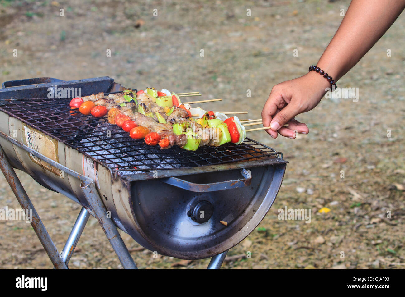 Grilling shashlik on barbecue grill. Selective focus Stock Photo
