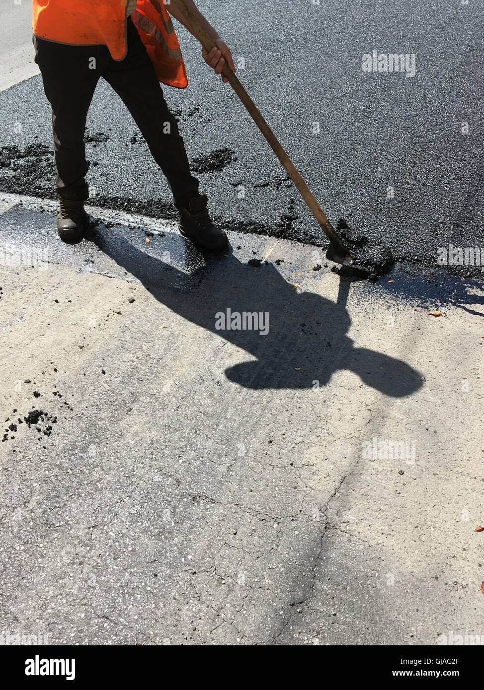 manual asphalting of a road in summer Stock Photo - Alamy