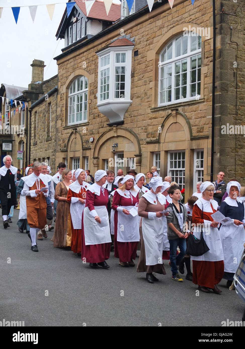 Villagers in costume process through the village of Eyam to Cucklet Delf during the annual Plague Commemoration Service. Stock Photo