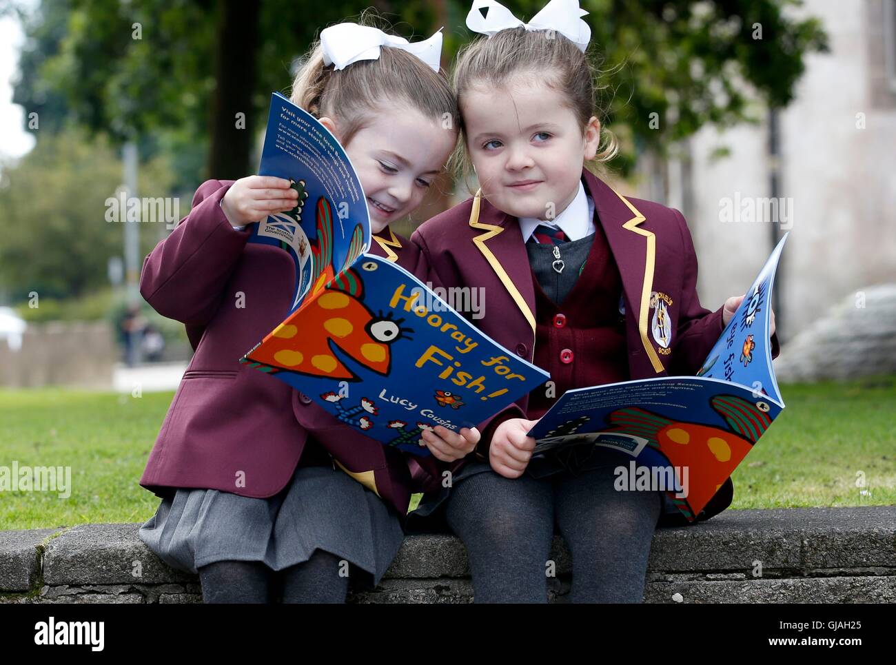 Orlagh (left) and Niamh Keen (4), one of 15 sets of twins from the Inverclyde area, pose for a photograph in Clyde Square in Greenock, ahead of their first day at school. Stock Photo