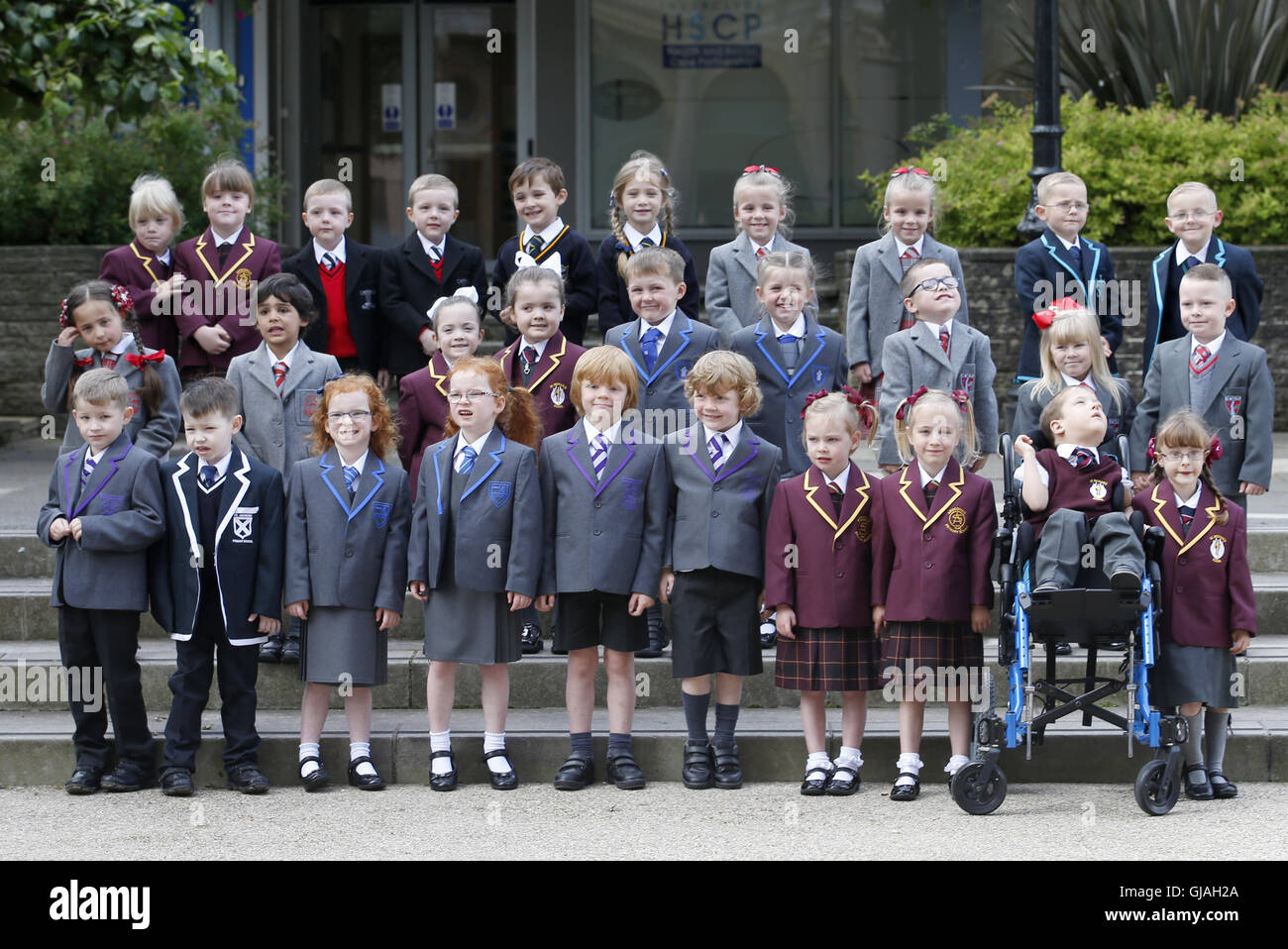 15 sets of twins, from the Inverclyde area, pose for a photograph in Clyde Square in Greenock, ahead of their first day at school. Pictured are (back row left to right) Emma and Grace McEleny (4), Fraser and Nathan McGrath (5), Jackson and Elizabeth Reid (5), Brooke and Skye Smith (4), Andrew and Thomas Stewart (4), (middle row left to right) Charlotte and Morgan Goyal (5), Orlagh and Niamh Keen (4), Charlie and Olivia Lyne (5), Cameron MacKenzie and Caitlin MacKenzie (NOT PICTURED) (4), Olivia and Rhogen McCurry (5), (front row left to right) Craig and Stuart Arthur (5), Caragh and Sophie Doi Stock Photo