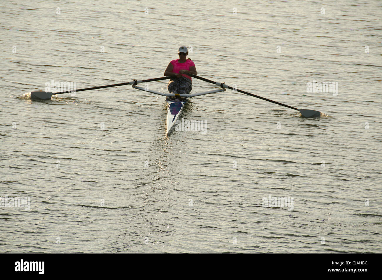 Woman in single scull on Erie Canal. Stock Photo