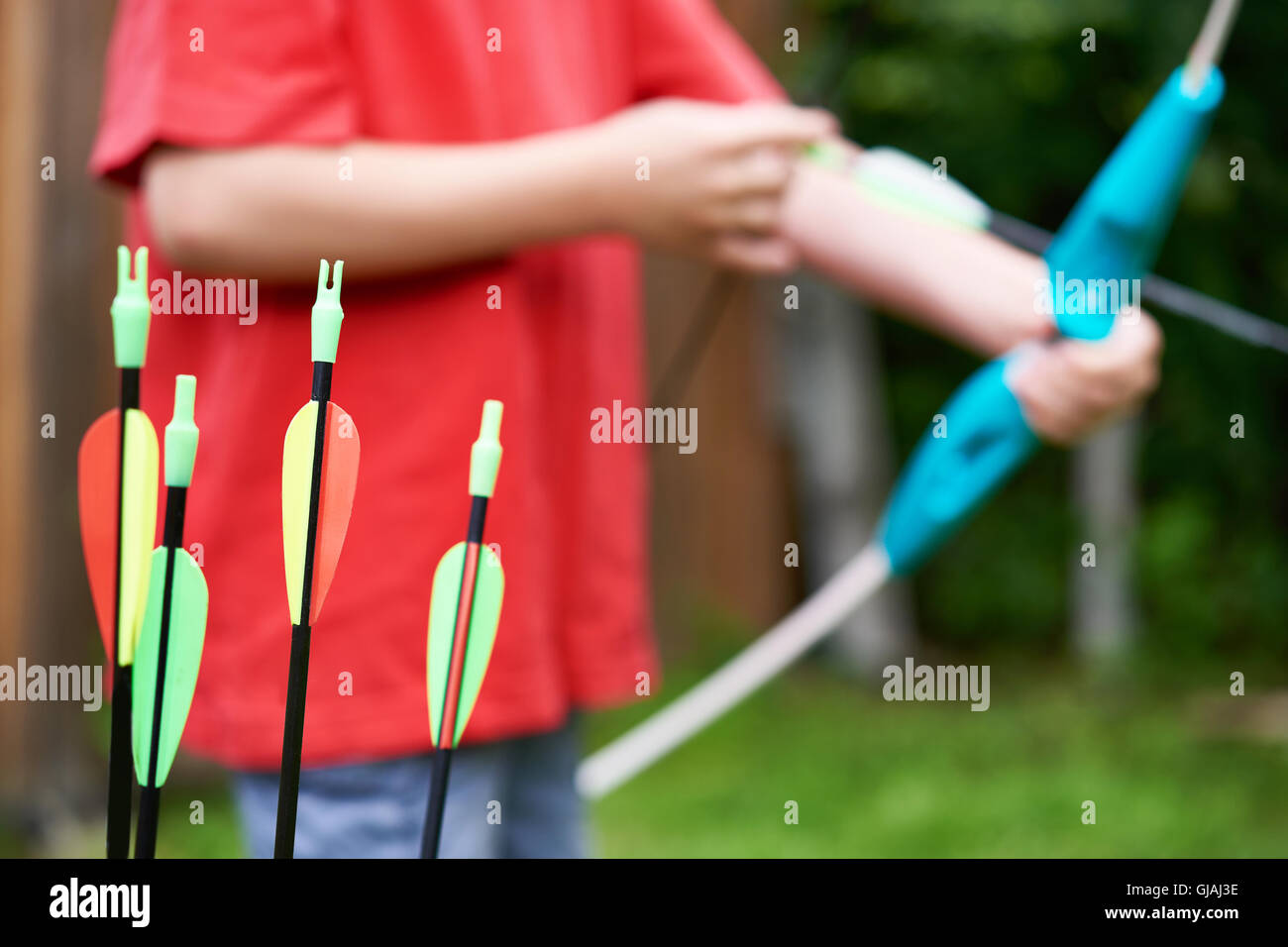 Little archer with bow and arrows outdoors Stock Photo Alamy