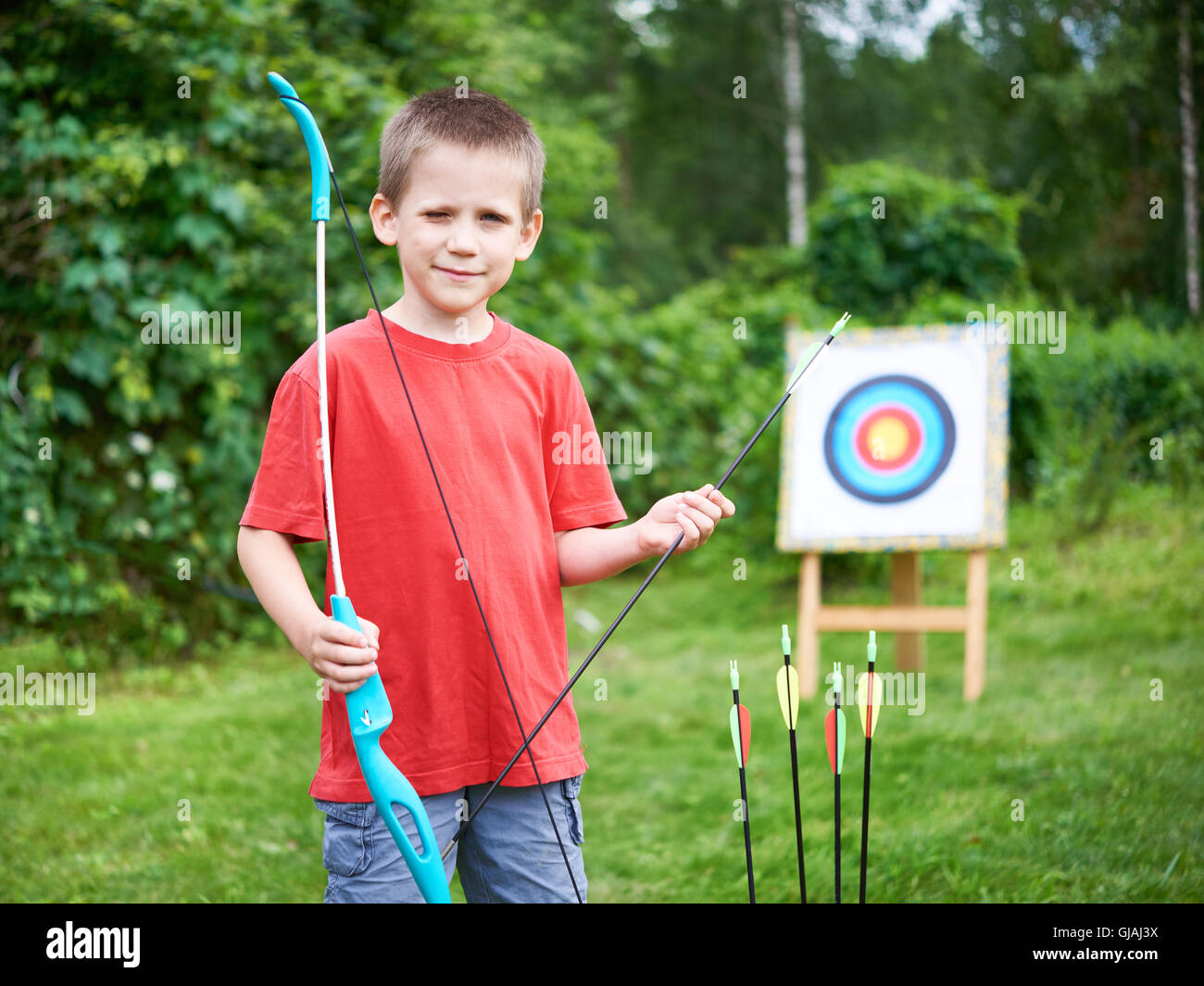Little archer with bow and arrows outdoors Stock Photo Alamy