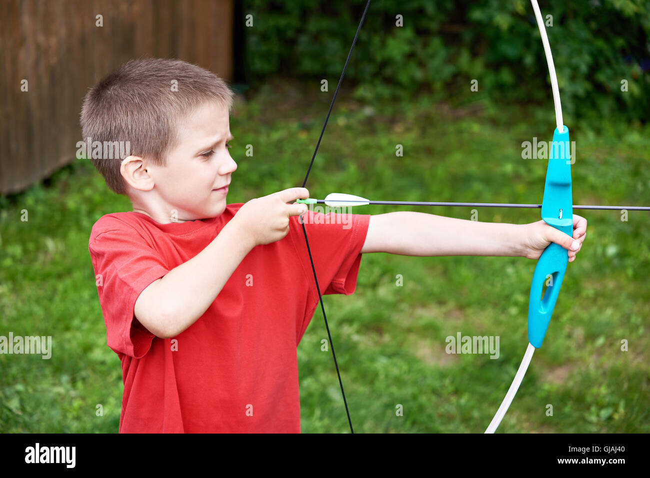 Little archer with bow and arrow outdoors Stock Photo Alamy