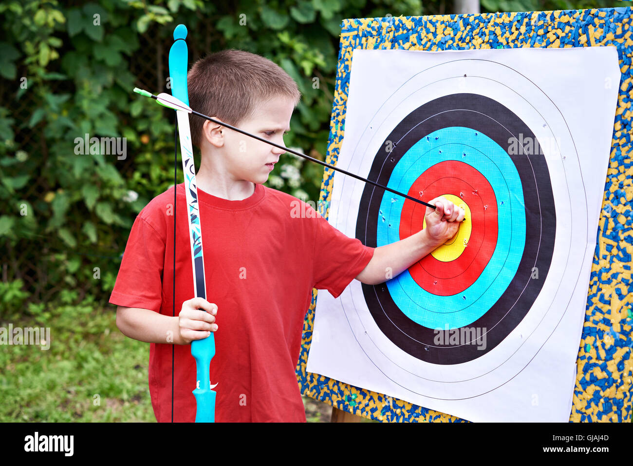 Little archer with bow and arrow outdoors Stock Photo Alamy