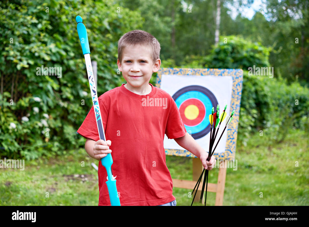Little archer with bow and arrows outdoors Stock Photo Alamy