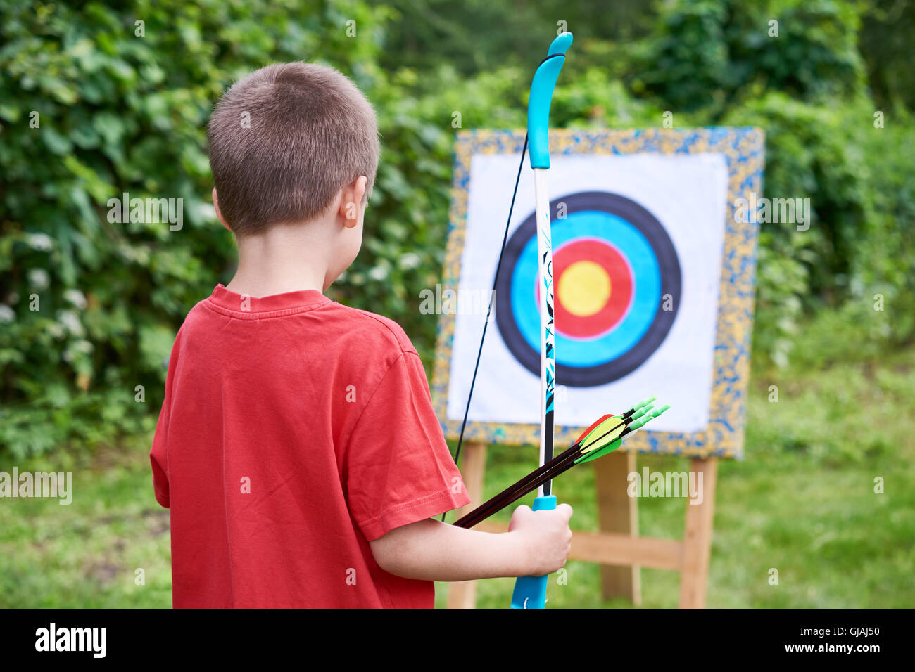 Little archer with bow and arrows outdoors Stock Photo Alamy