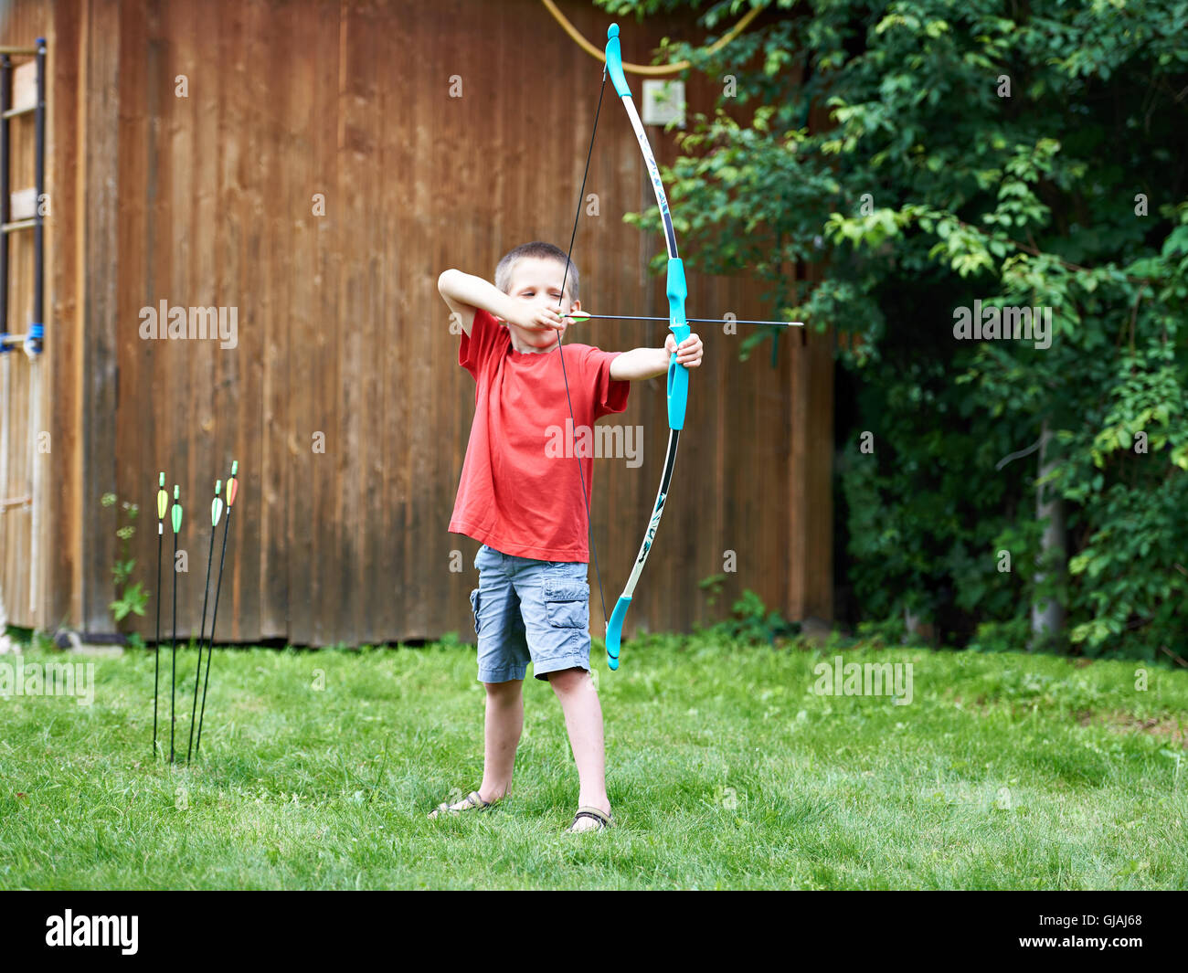 Little archer with bow and arrows outdoors Stock Photo Alamy