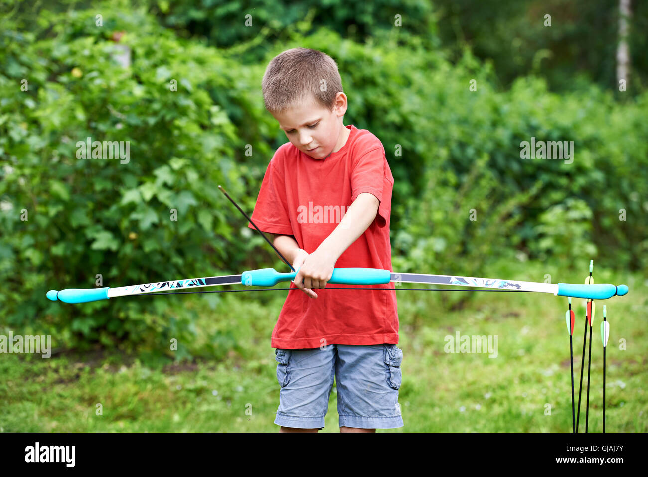 Little archer with bow and arrows outdoors Stock Photo Alamy