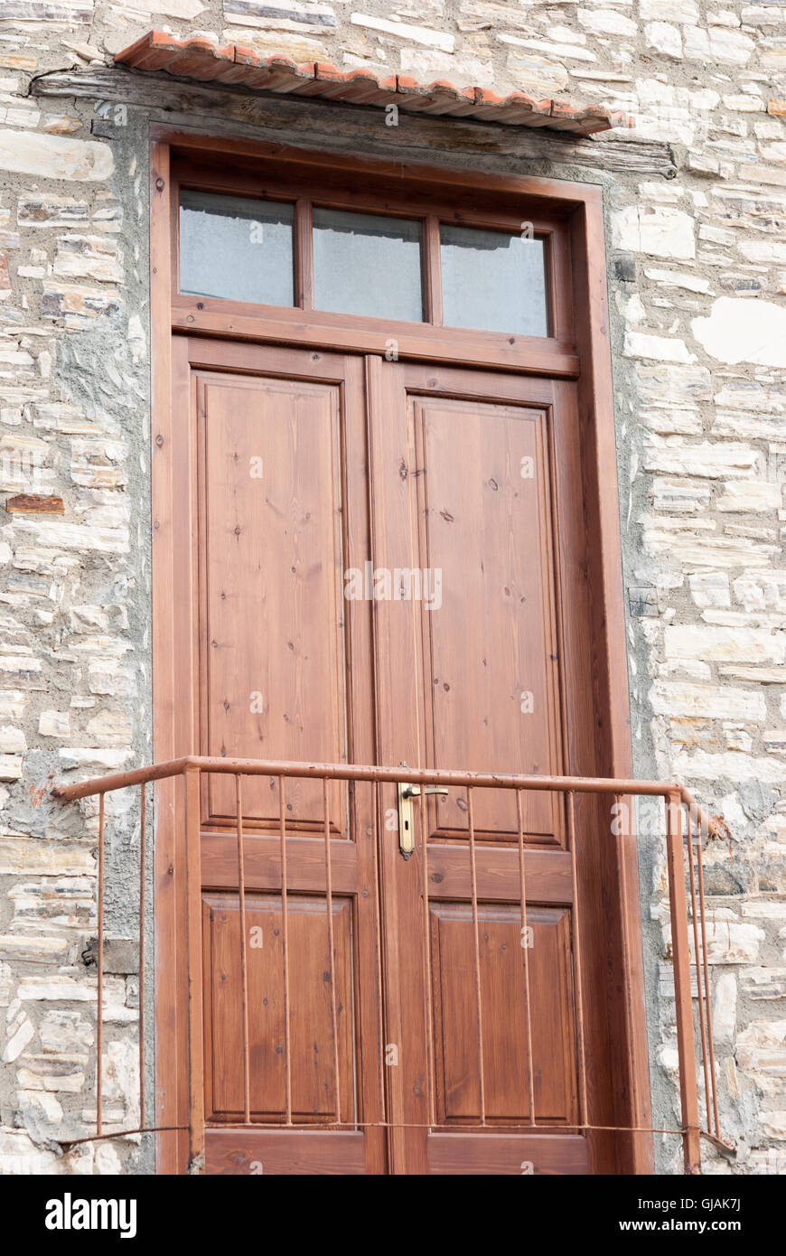 Old balcony with the rustic wooden door on the facade of traditional ...