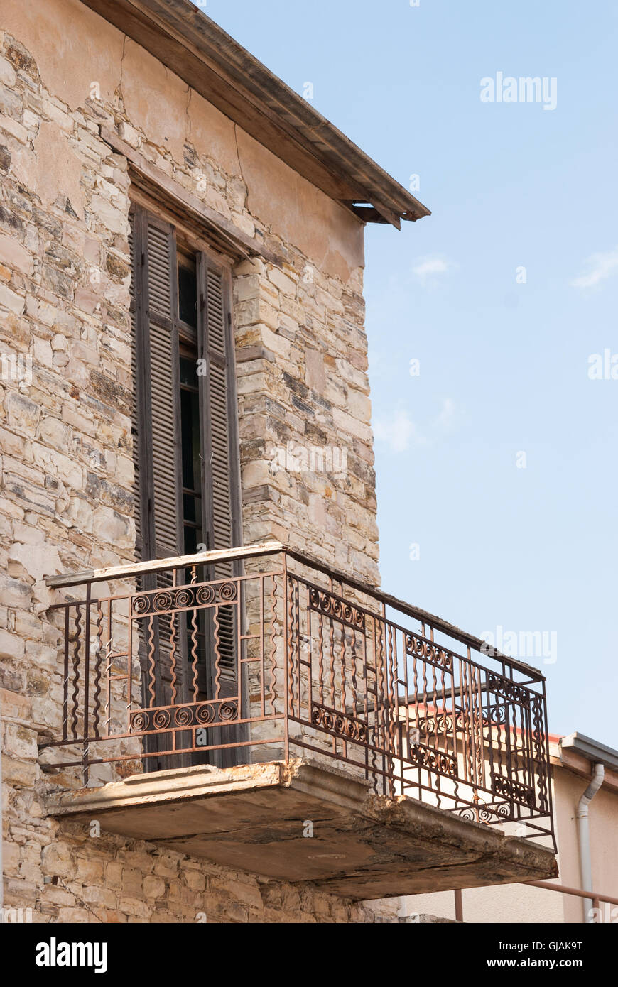 Old balcony with the rustic wooden door on the facade of traditional ...