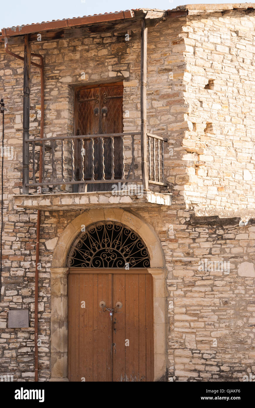 Old brown wooden balcony with wooden door on the facade of the ...