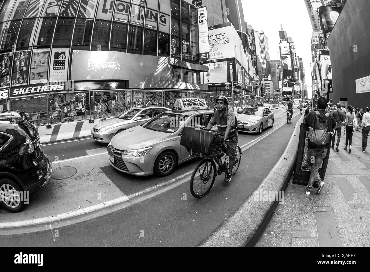 Yellow cabs, bicyclists and pedestrians on Times Square. Stock Photo