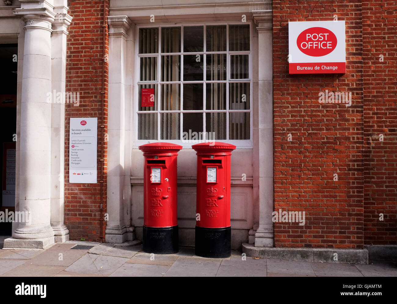 Chichester Post Office with red letter boxes and burea de change Stock Photo