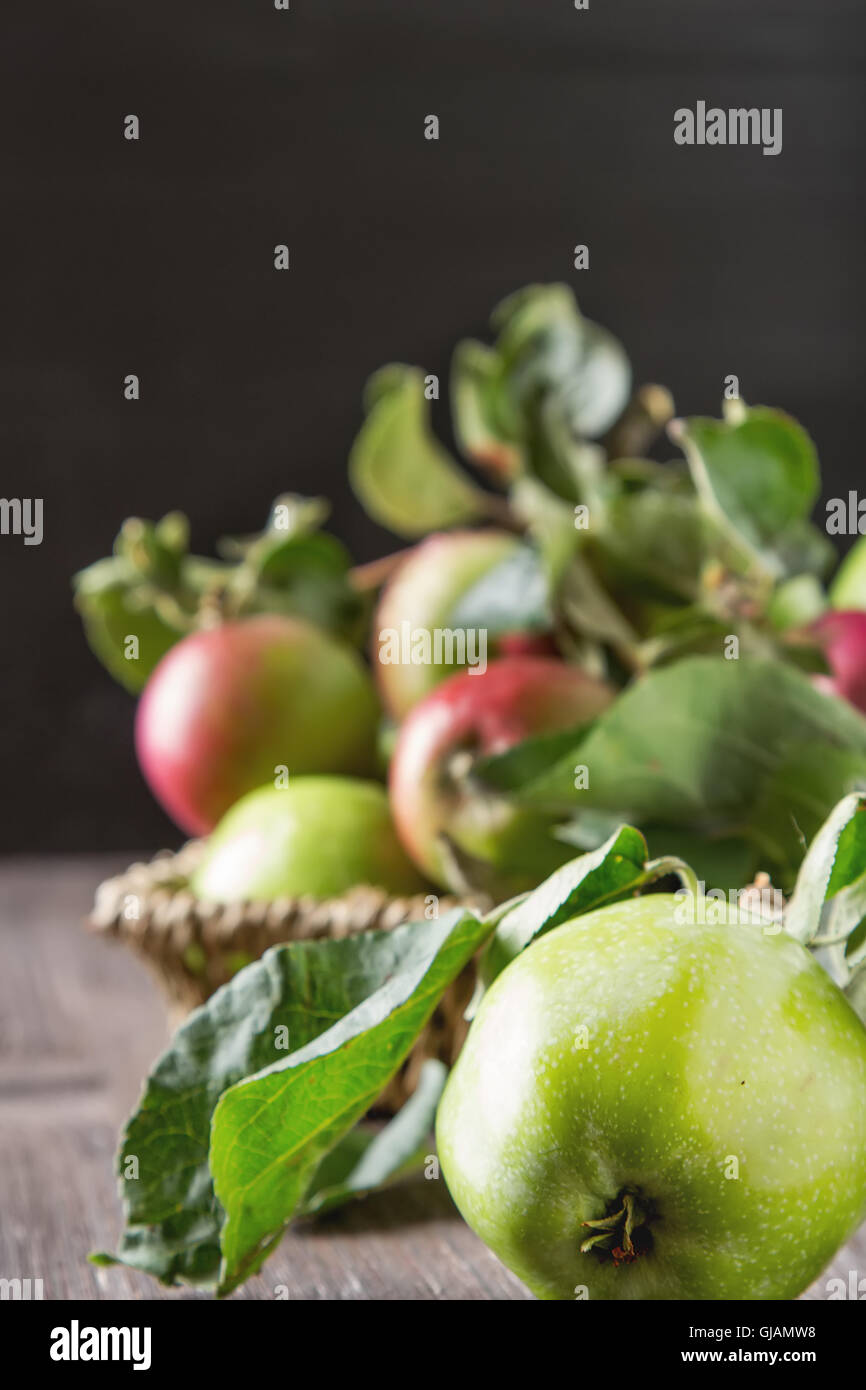 Ripe green and red apple with leaves. Dark wood background Stock Photo ...