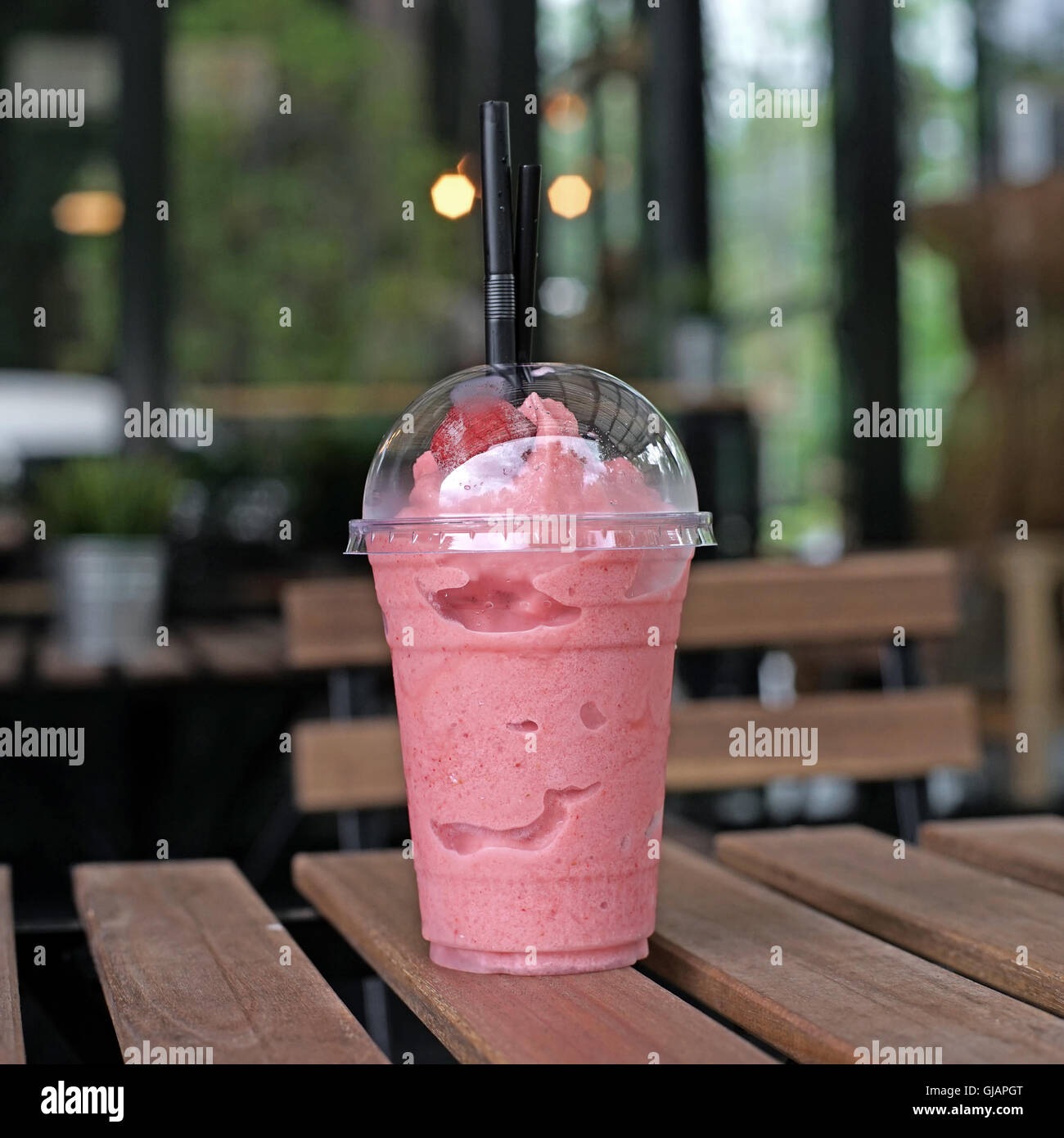 https://c8.alamy.com/comp/GJAPGT/sweet-strawberry-smoothie-in-takeaway-cup-on-wooden-table-GJAPGT.jpg
