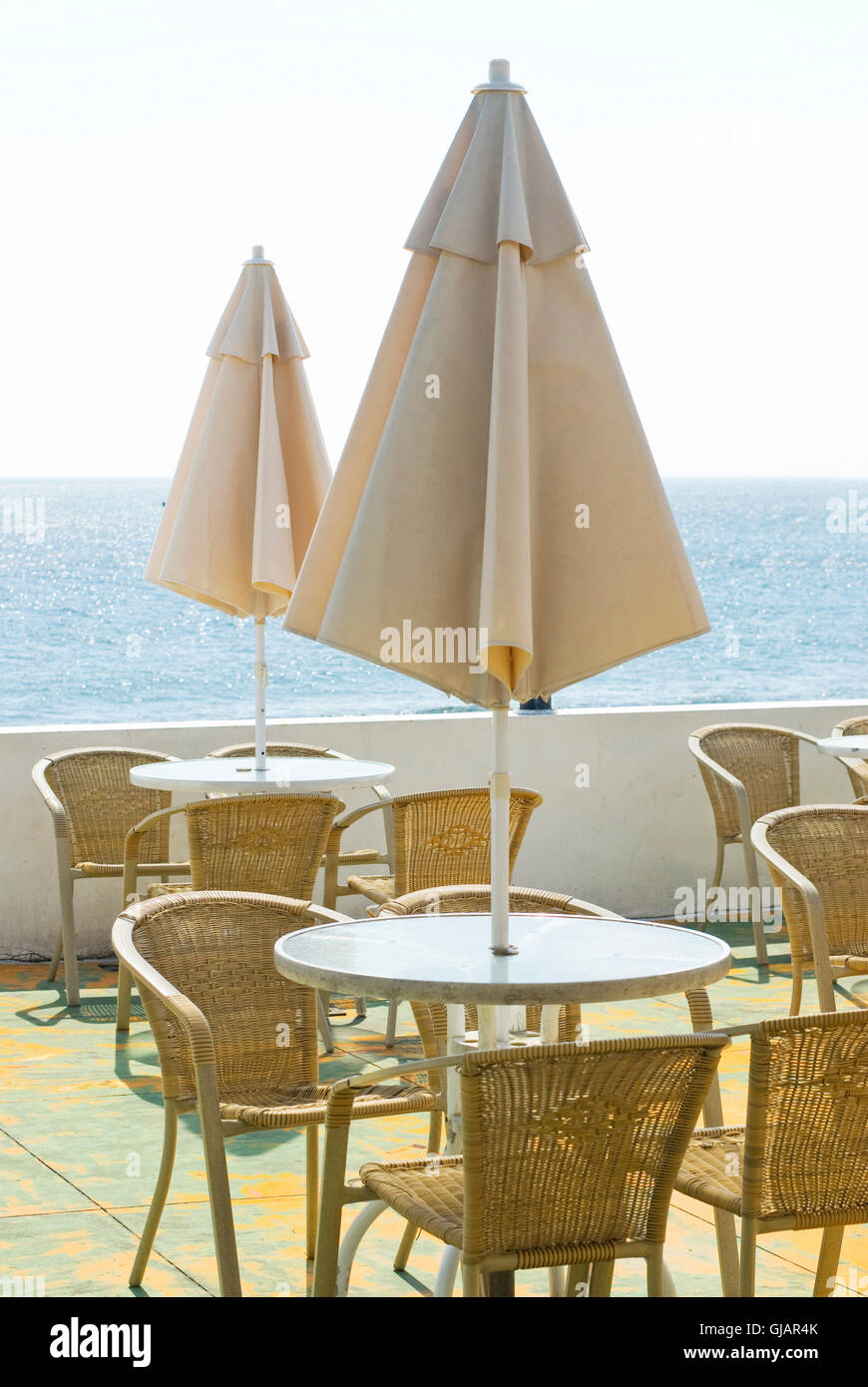 coffee table and umbrella in the seashore Stock Photo - Alamy