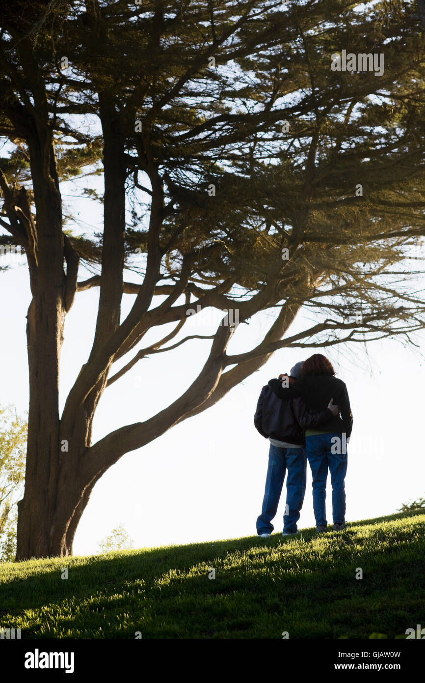Couple Embracing on Hill Stock Photo