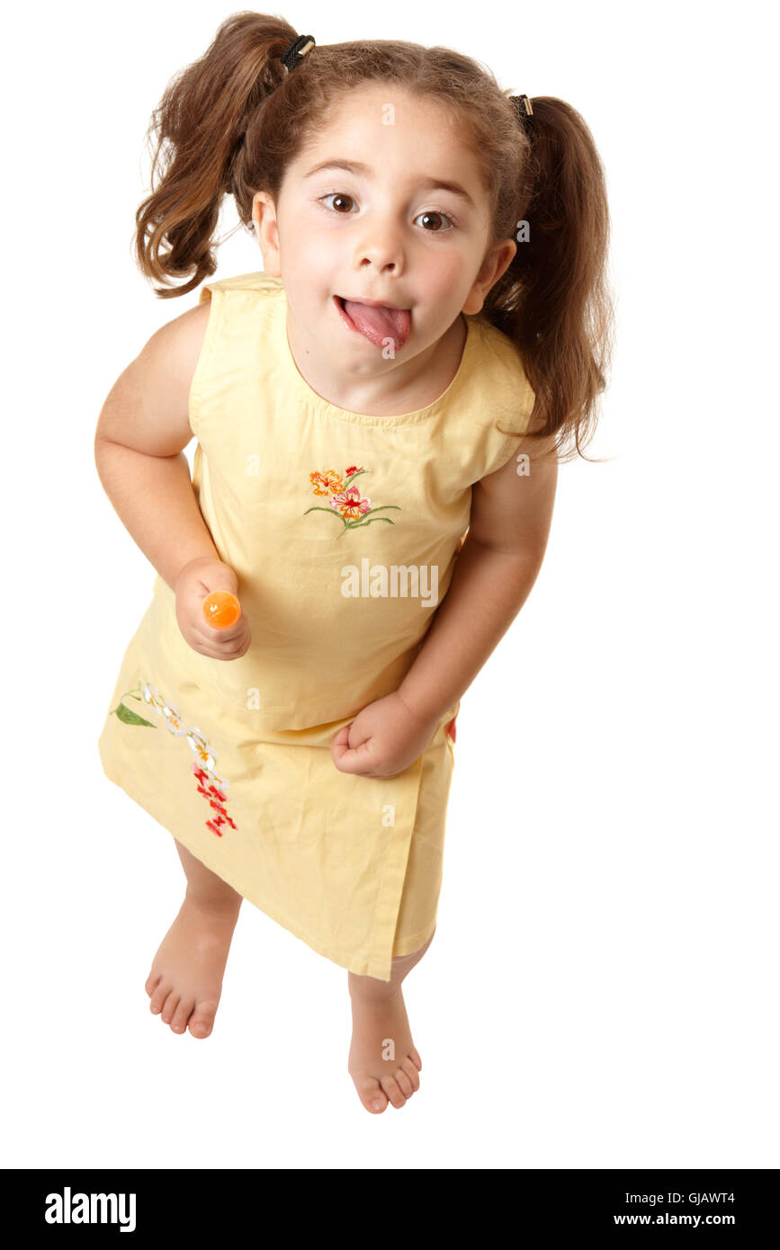 Adorable girl looking up and licking lips Stock Photo