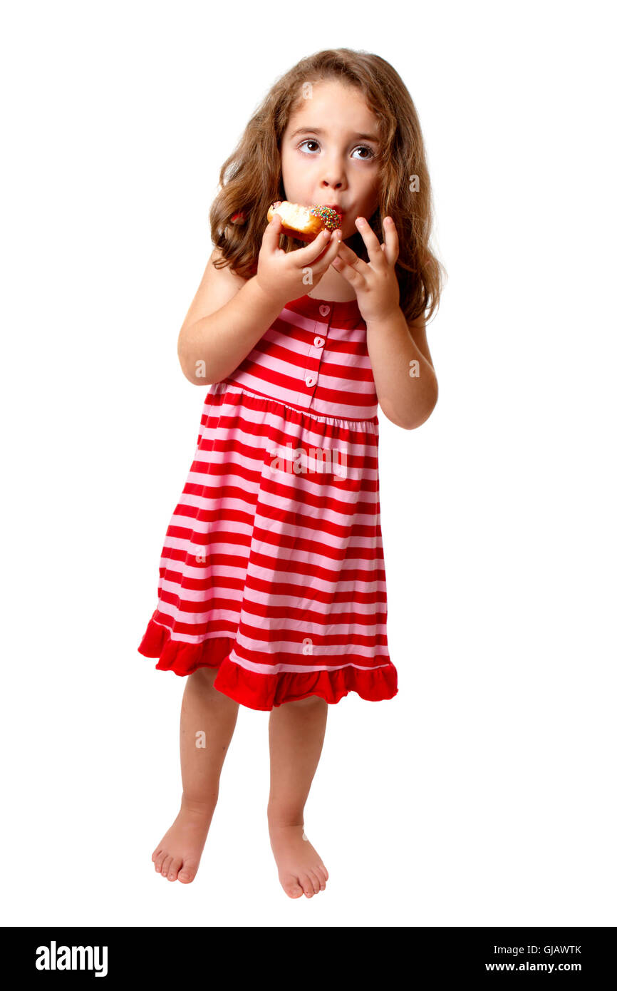 Little girl eating doughnut Stock Photo