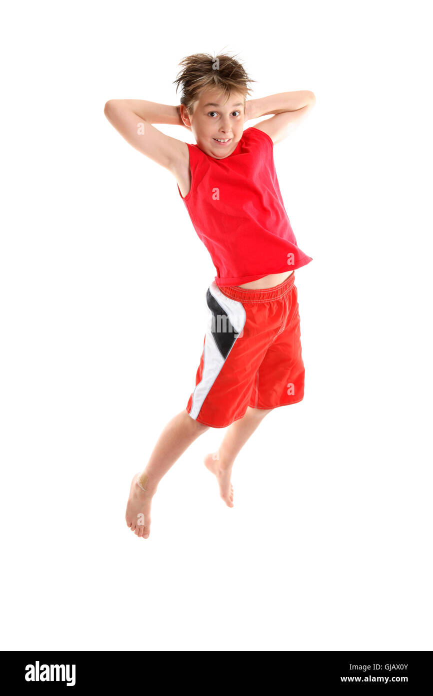 Boy jumping hands behind head Stock Photo Alamy