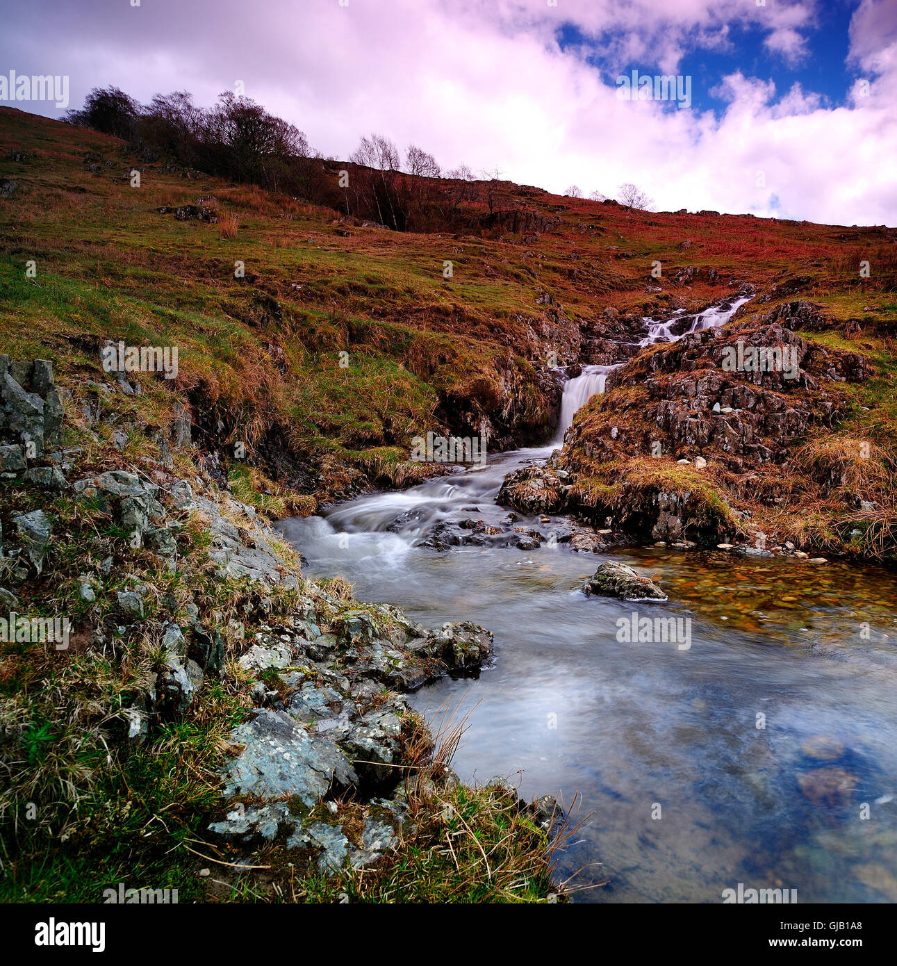 Waterfalls and the stream on the hillside Stock Photo