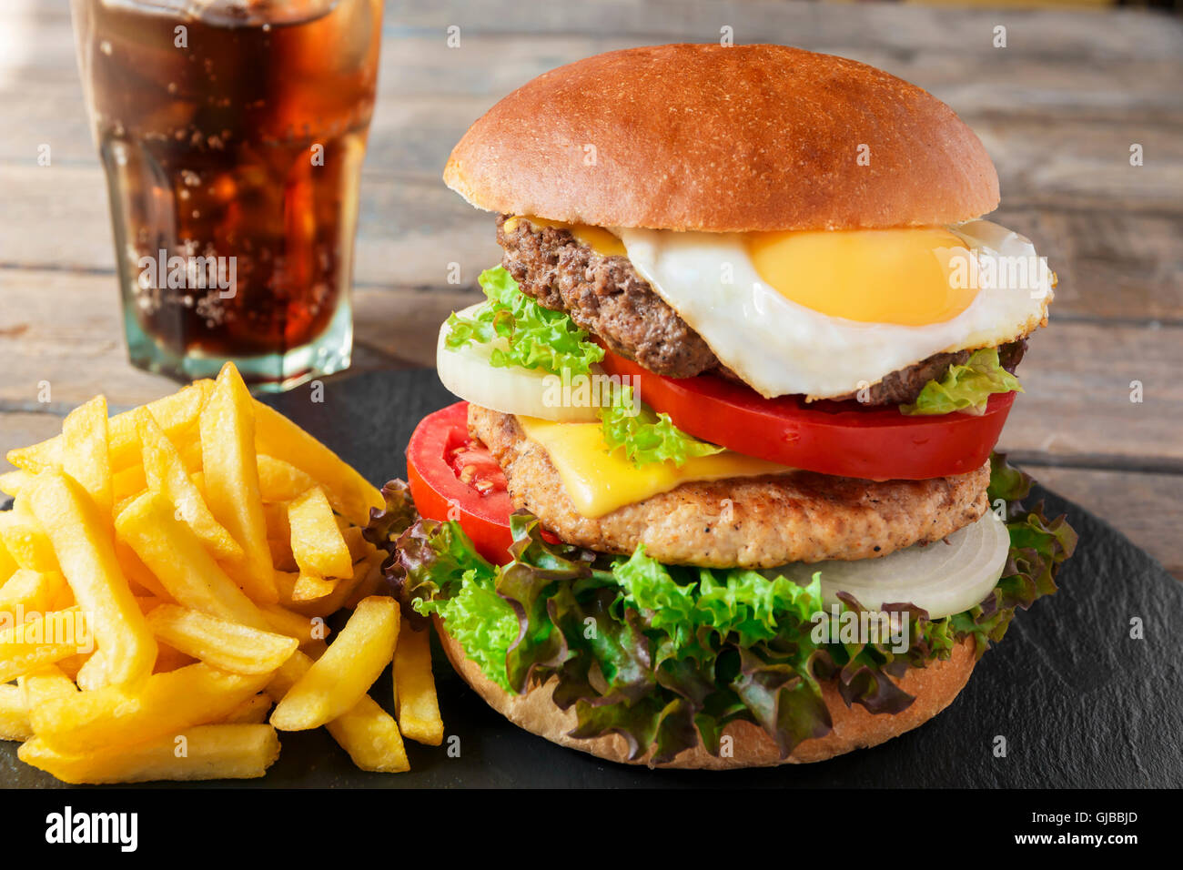 hamburger meat cutlet egg cheese french fries Stock Photo Alamy